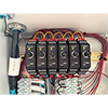 A photo of 6 CTC SC300 Series Signal Conditioners mounted on a DIN rail inside of an enclosure.