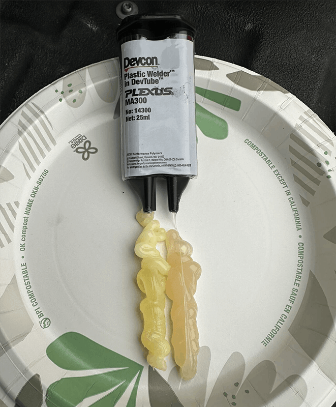 A photo of CTC MH109-2A two-part Devcon Plastic Welder being dispensed onto a paper plate.
