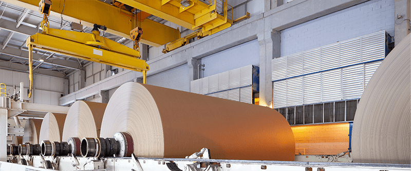 Rolls of paper on machinery in a paper factory.