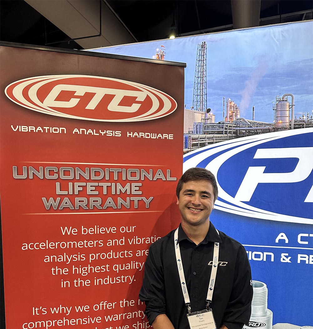 A CTC Sales Team member wearing a black CTC polo shirt at a trade show, standing in front of a blue PRO Line banner and a red CTC Line banner