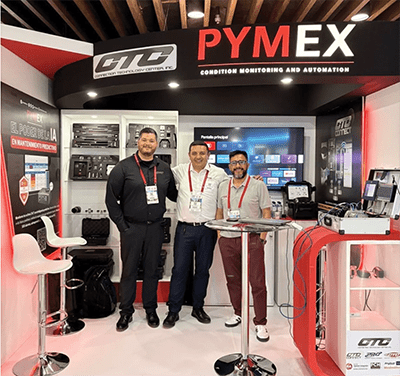 One CTC employee and two PYMEX employees stand in front of a CTC and PYMEX branded trade show booth.