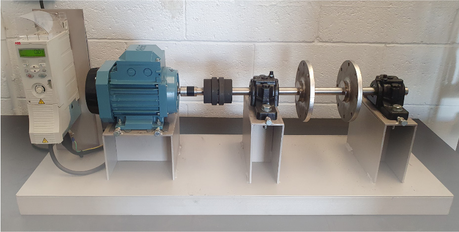 photograph of the trial rig setup including a blue motor and a shaft