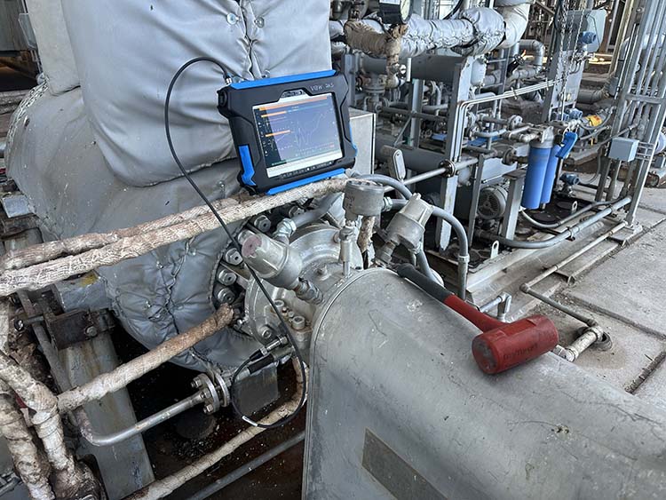 Photograph of a boiler feed pump with VIBWorks King data analyzer and mallet for impact testing
